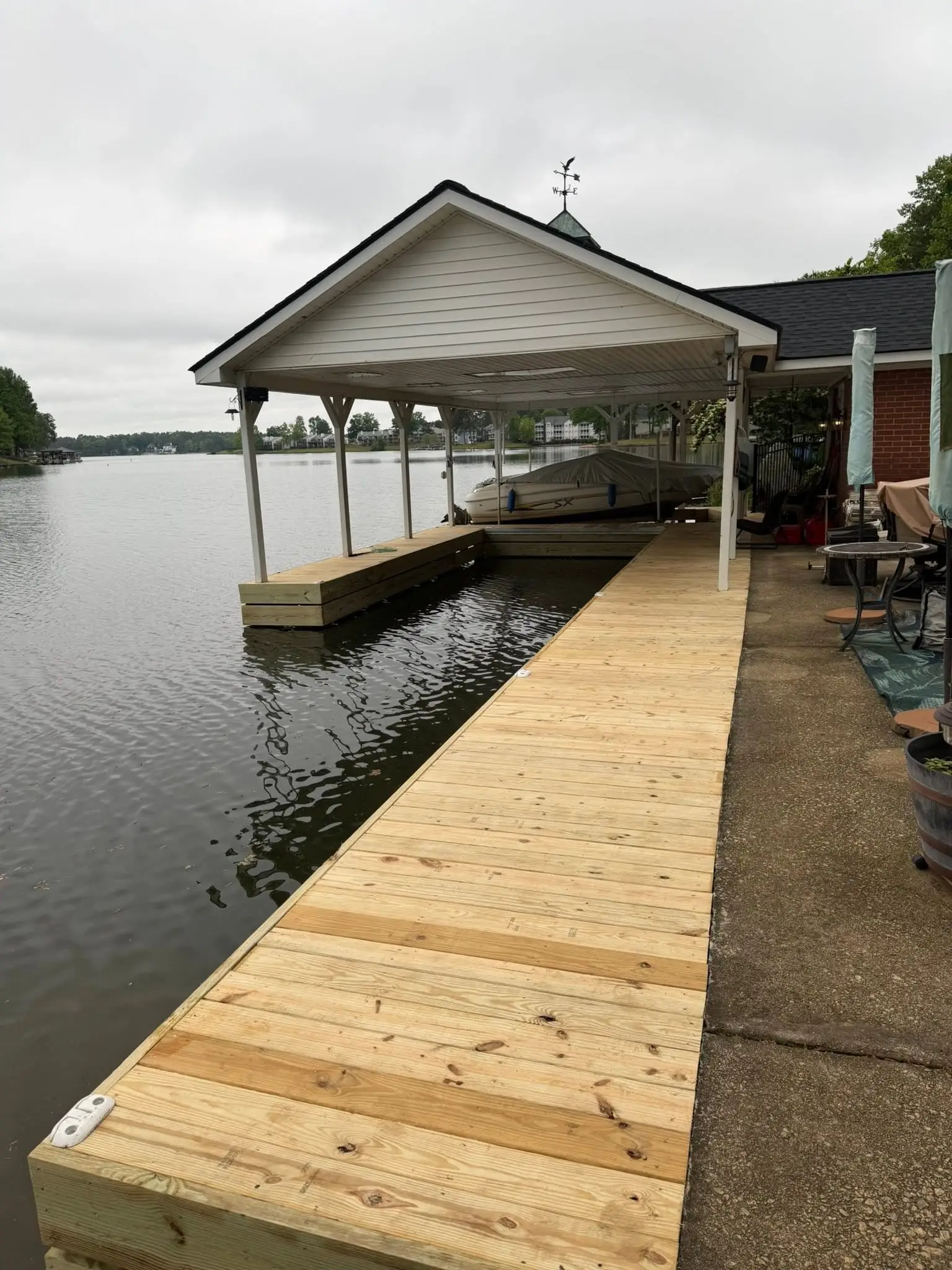 New dock decking and fascia board over lake water