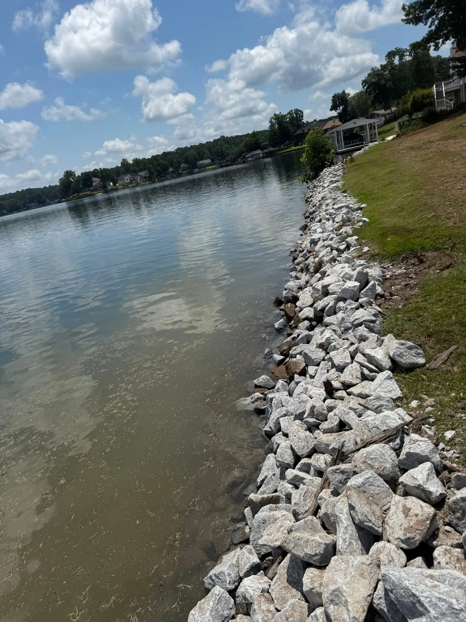 Rip-rap stone seawall along a lake shoreline