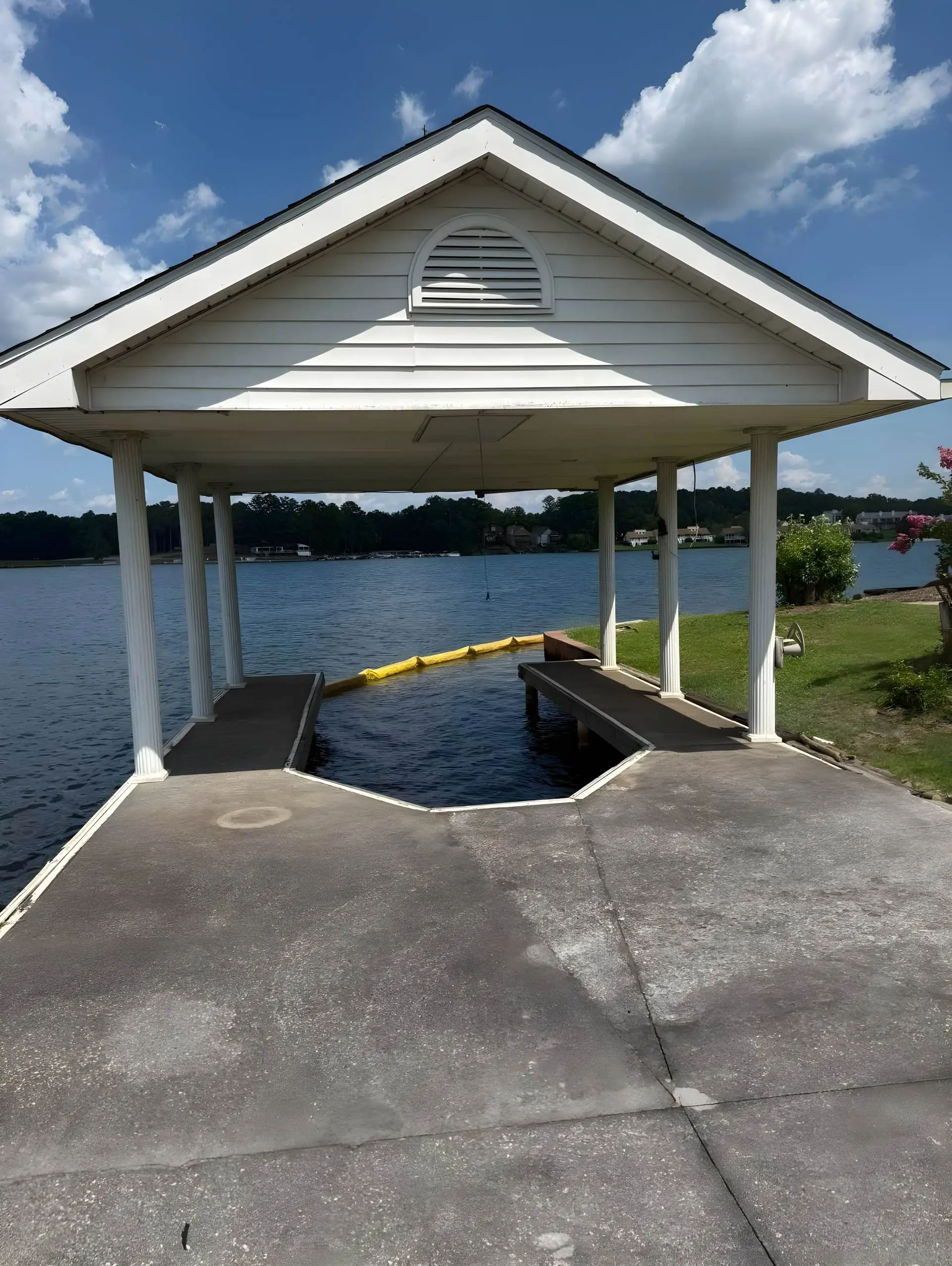 Boathouse pavilion with concrete pad and swim area, still under construction