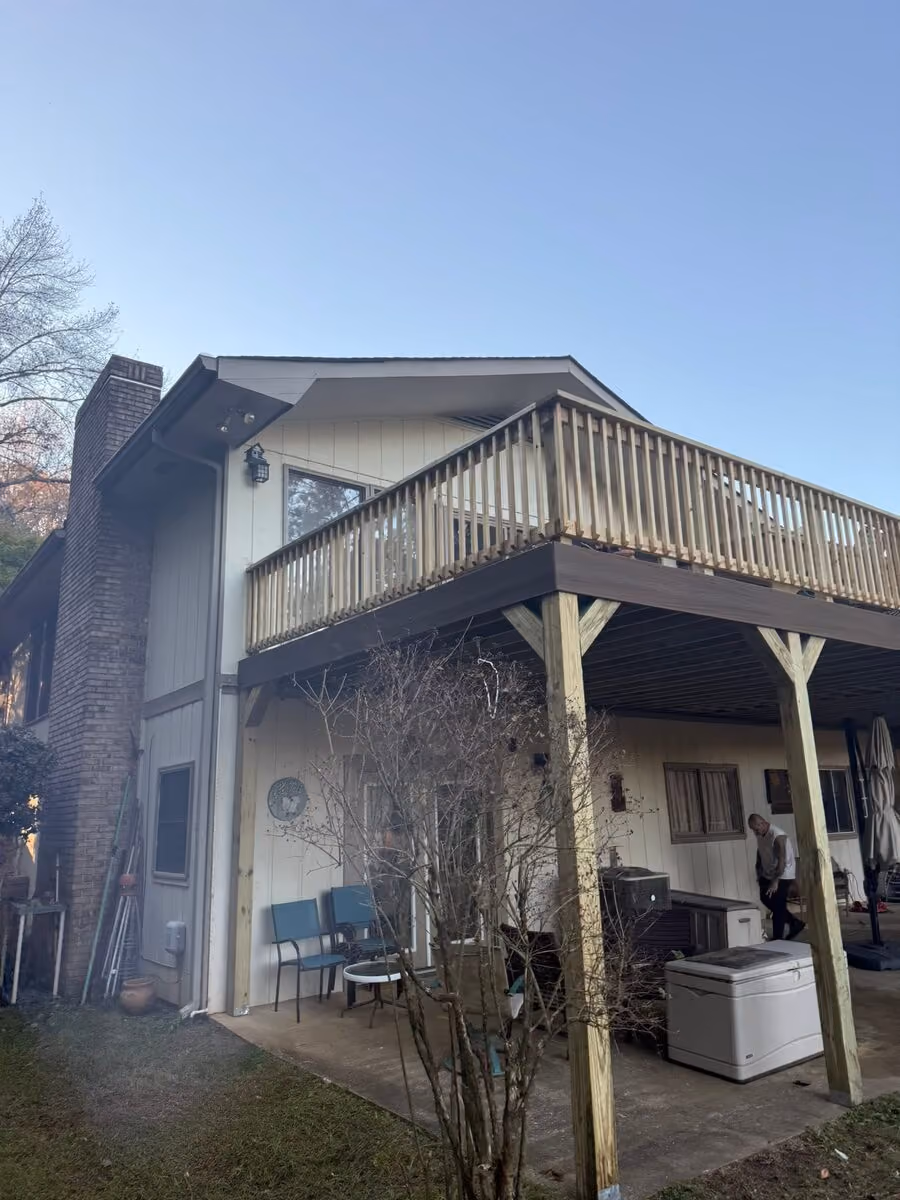 Large elevated deck rebuild with a covered patio below, crew on site