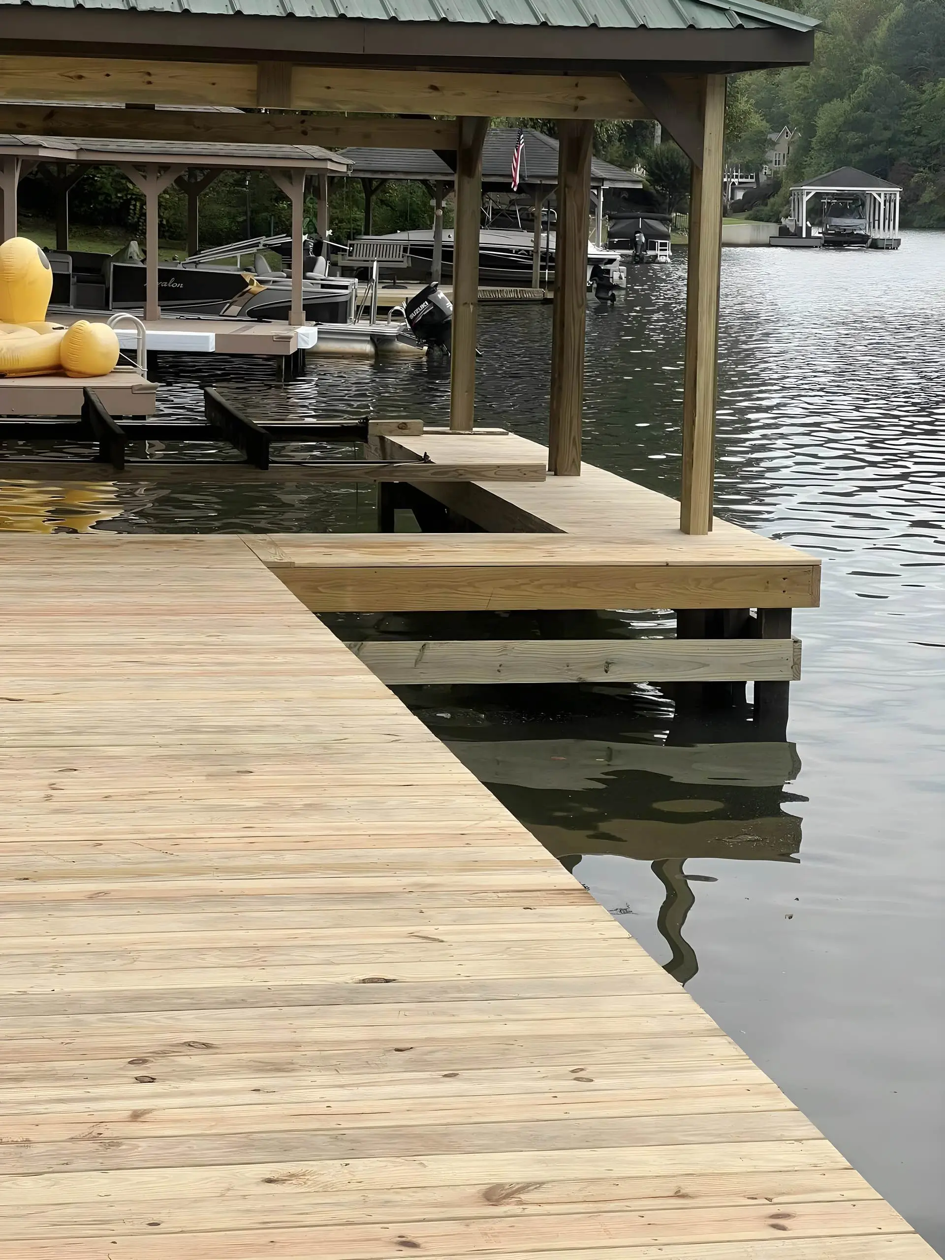 A covered boathouse and dock at the edge of a west Georgia lake
