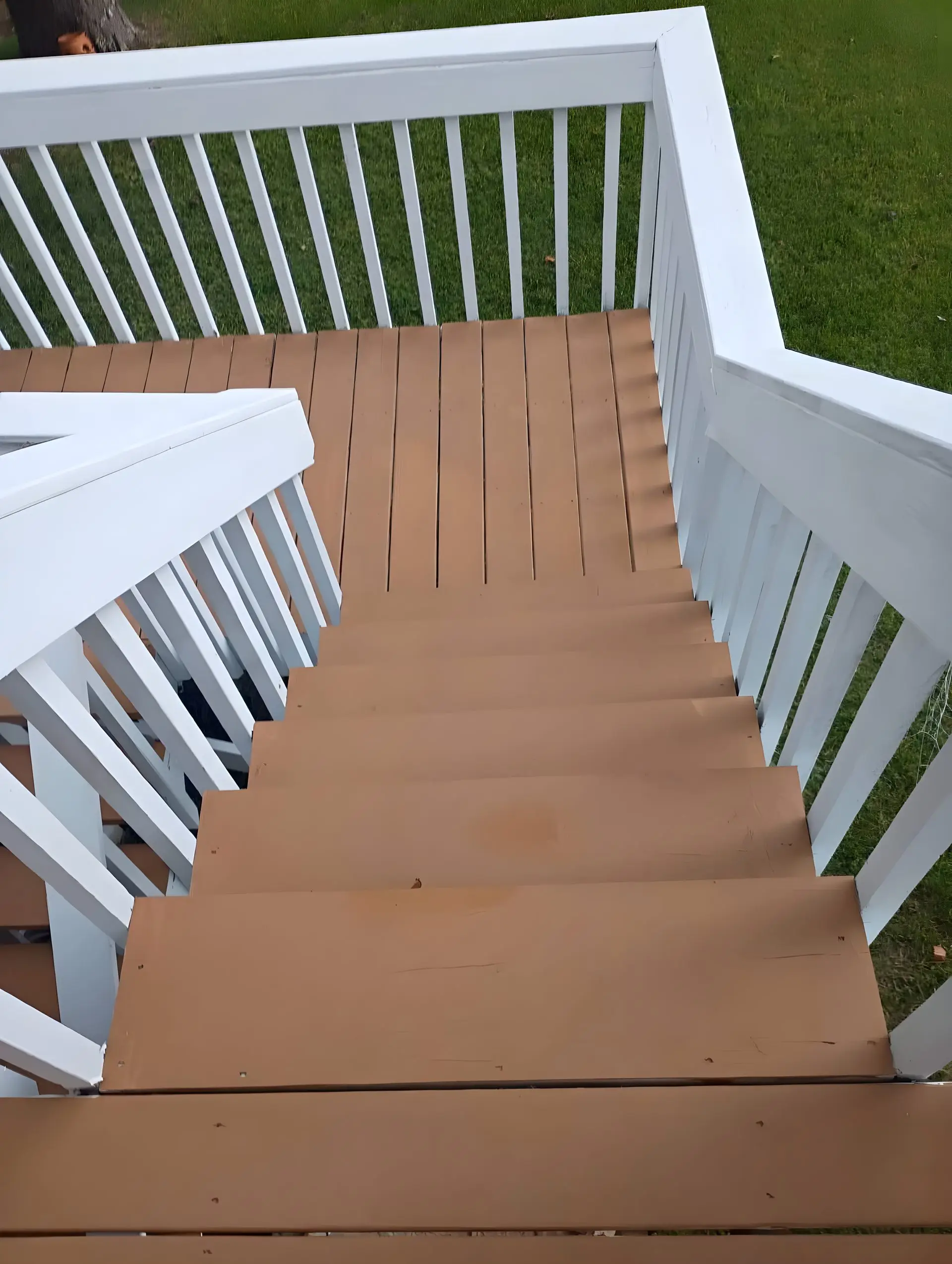 Finished stained deck with white rail and matching stairs