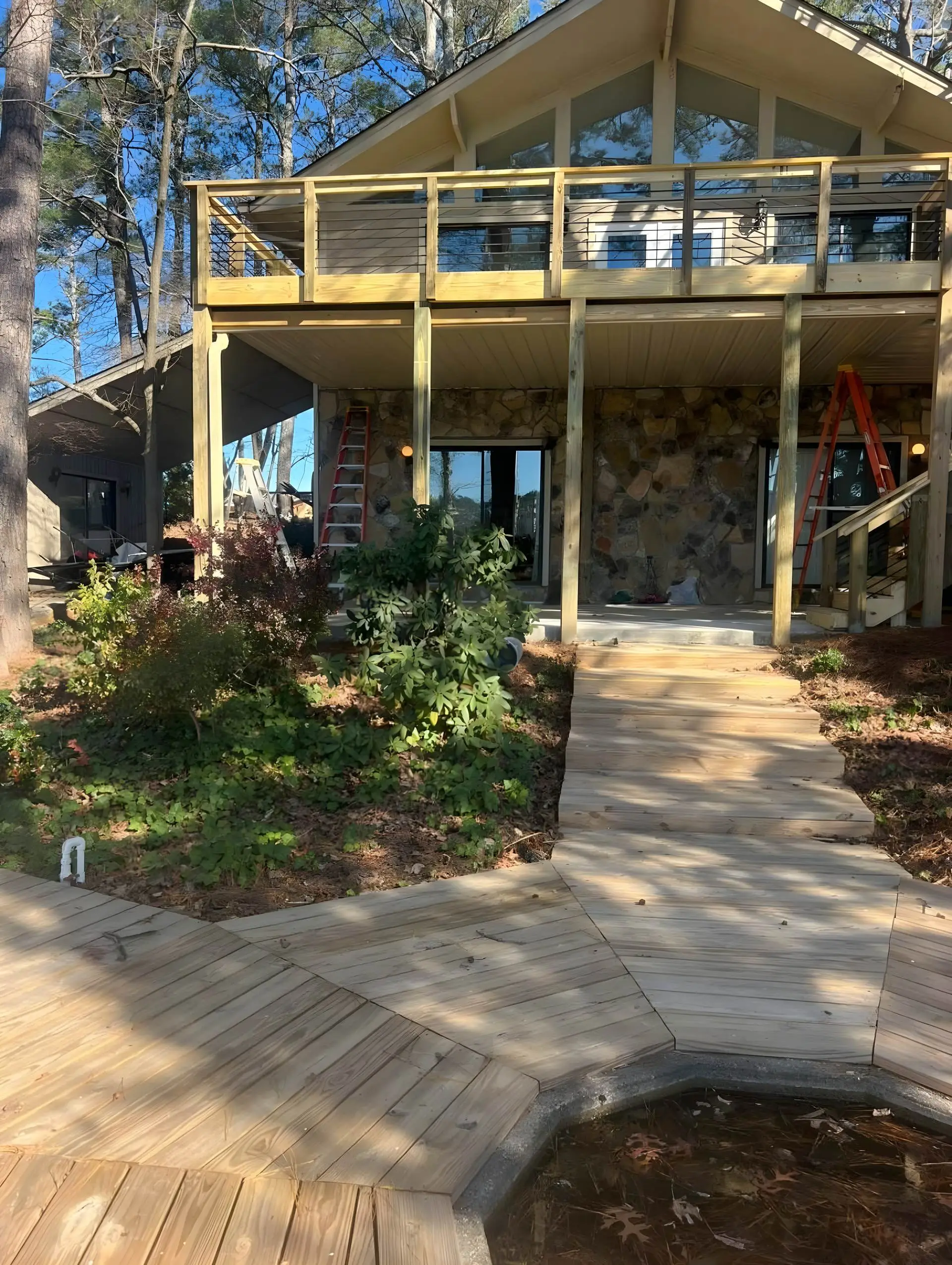 Elevated cable-rail deck under construction at a chalet-style home