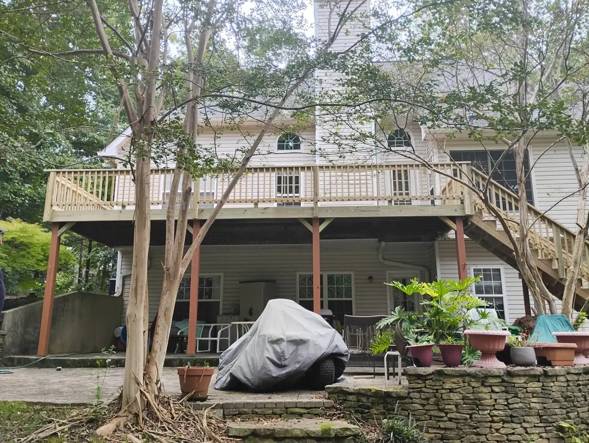 Wraparound deck with new framing and decking and a rebuilt stair run